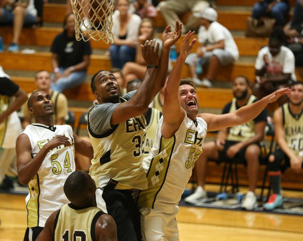 Alumni players fight for a rebound during a series of alumni games to help raise money for the boys and girls basketball programs at East Hall High School on Tuesday, July 16, 2019.